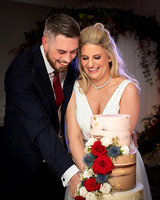 Natural photo of bride and groom cut their wedding cake
