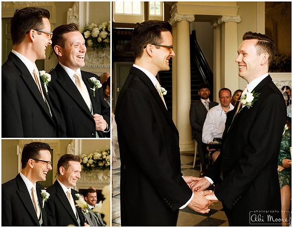 Two grooms at a same sex wedding smile during their ceremony
