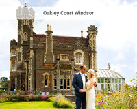A bride and groom smile at each other in the shadow of Windsor's Gothic Oakley Court