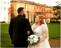 Bride & Groom smile at each other with Beaumont Estate in the background