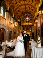 A couple stand in the chapel at Beaumont Estate Old Windsor, beautiful stained glass window in the background