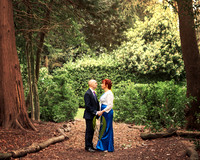 A wedding couple smile at each other surrounded by the woodland at the Berystede in Ascot