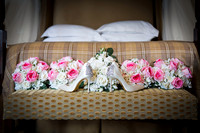 Bridal shoes and bouquets photographed on a chaise in the Berystede's bridal suite