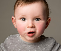Close-up photo of baby boy making cute expression