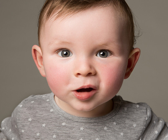 Close-up photo of baby boy making cute expression
