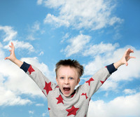 Young boy appears to be falling through the cloudy sky - reaching out and yelling