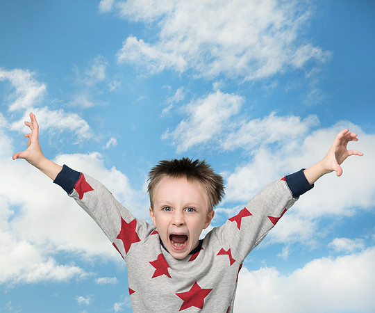 Young boy appears to be falling through the cloudy sky - reaching out and yelling