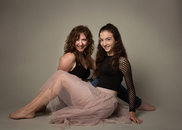 Mother and teenage daughter photographed in a studio
