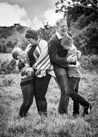 Family giggle together during relaxed photoshoot outside (in black & white)