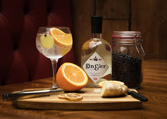 Royal wedding gin photographed with botanicals and orange and ginger
