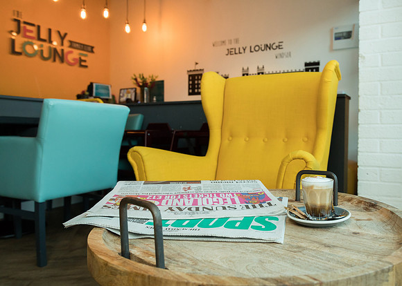 Professional photograph of the foyer of the Jelly Lounge in Windsor, table set with Sunday papers and coffee