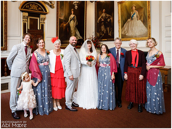 A group photo taken at a wedding inside Windsor's Guildhall