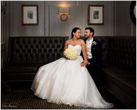 Due to rain, bride & groom are photographed sitting together inside at the Compleat Angler in Marlow