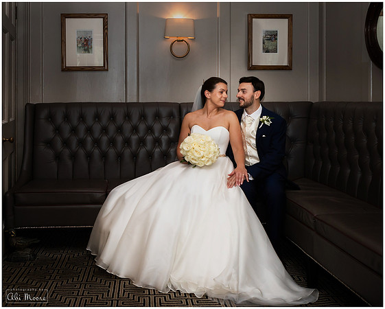 Due to rain, bride & groom are photographed sitting together inside at the Compleat Angler in Marlow