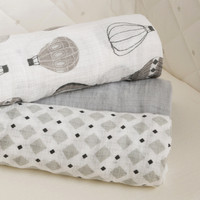 Pile of rolled grey baby muslins