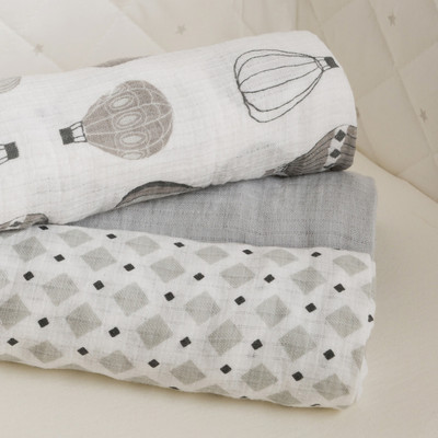 Pile of rolled grey baby muslins