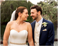 Bride & groom smile at each other by the river on their wedding day at The Compleat Angler in Marlow