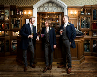 A groom and his groomsmen enjoy a drink inside the gothic interior of Oakley Court
