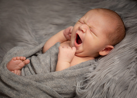 Baby boy yawning during photo shoot