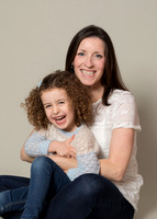 Mother & daughter giggle on studio photoshoot