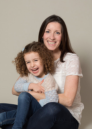 Mother & daughter giggle on studio photoshoot