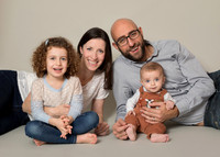 Family with daughter and baby son photographed in relaxed studio setting