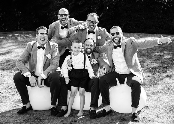 The groom, best man, ushers and page boy have fun on space hoppers at this Wasing Park wedding