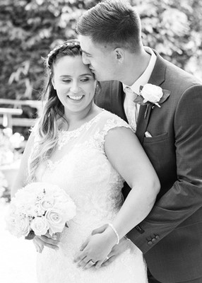 Groom kisses bride outside at Surrey wedding