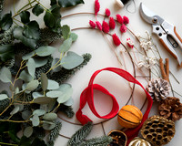 A flatlay of various elements of a wreath-making kit