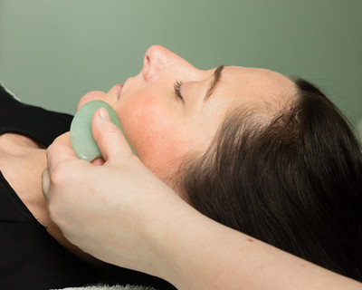 GuaSha being used during a\ Zone Face Lift facial reflexology treatment