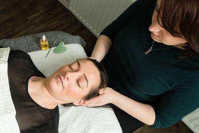 Michaela Spear of Windsor's Spear Reflexology givng a facial relexology and Zone Face Lift treatment
