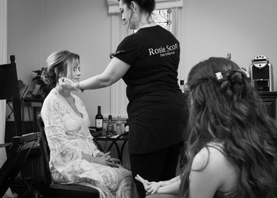 bride having her hair and make-up done on her wedding day