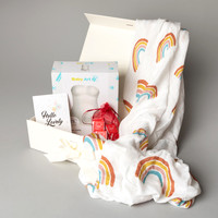 A gift set of baby and maternity products photographed in a studio setting