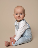 studio photo of baby boy in blue outfit