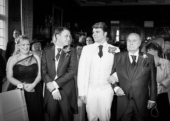Two grooms first look at each other after one is walked down the aisle by his grandfather