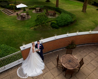 A bride and groom are photographed from above on the balcony of Macdonald Berystede Ascot