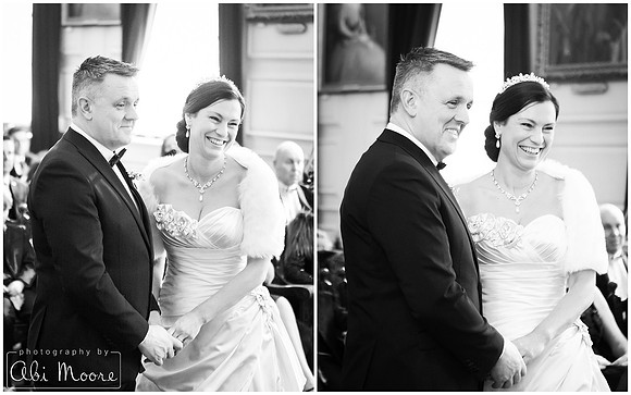 Bride & groom laugh during their ceremony at Windsor Guildhall, photographed in black & white