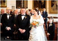 Bride & groom smile just after she is walked down the aisle by their son at Windsor Guildhall