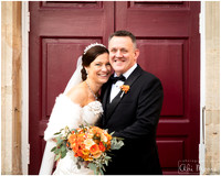 Bride & groom laugh together in front of Windsor Guildhall's red doors