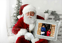 Santa holding a photo frame containing a picture of two children