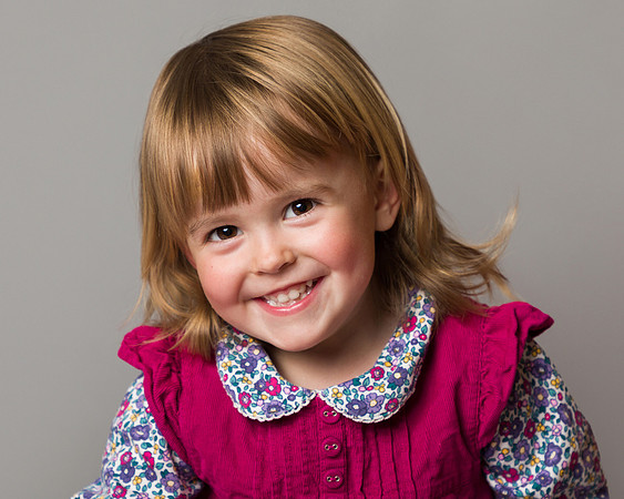 Young girl smiles photographed in a studio