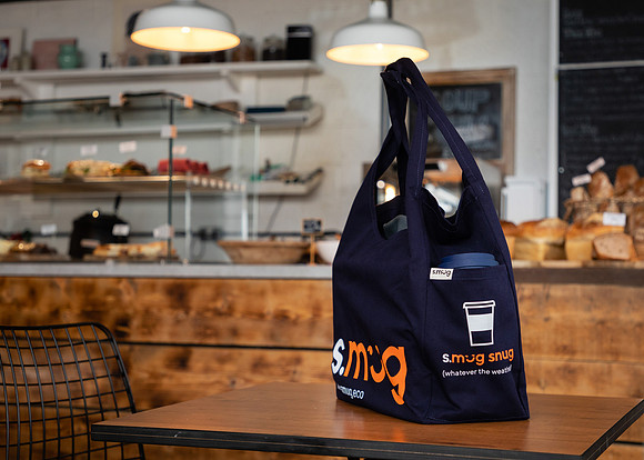 A tote bag photographed on a table in a cafe