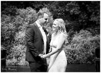 Natural wedding photo of bride and groom on the jetty at Oakley Court in black & white