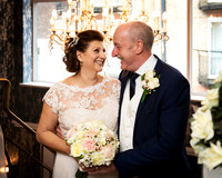 A wedding couple smile at each other inside M Gallery Castle Hotel Windsor