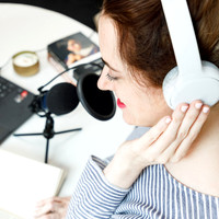 Lady recording a podcast as part of her business marketing.