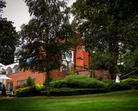 A wedding couple are dwarfed in the grounds of the Berystede hotel in Ascot