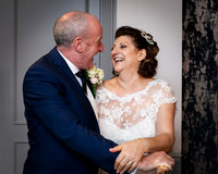 A bride and groom laugh together within Windsor's Castle Hotel