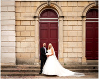 Wedding photo of bride and groom outside Windsor Guildhall's red doors