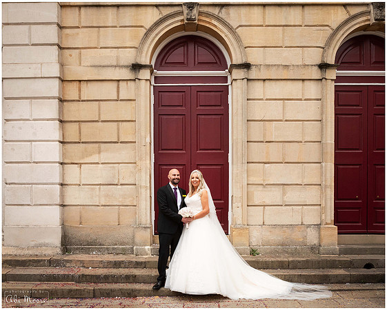 Wedding photo of bride and groom outside Windsor Guildhall's red doors