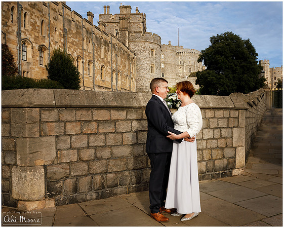 Bride & Groom look lovingly at each other outside Windsor Guildhall